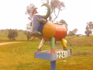 A very colorful and country-esque roadside mailbox.